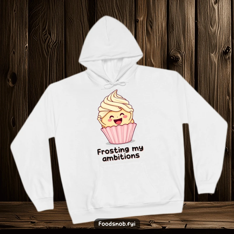 Funny hoodie featuring a smiling cupcake character frosting a larger cupcake, offering warmth and a sweet, humorous baking theme.