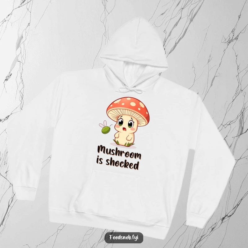 Funny hoodie showcasing a wide-eyed mushroom character looking astonished as a tiny olive speeds past.